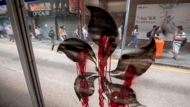 A black version of the five-petal Hong Kong Bauhinia, which features on the Hong Kong flag, is displayed on the street the morning after clashes.