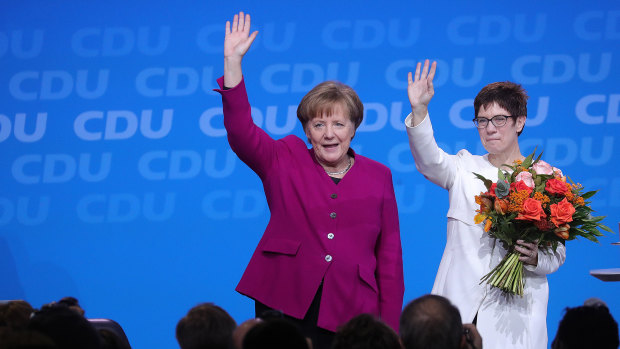 German Chancellor Angela Merkel congratulates her CDU colleague Annegret Kramp-Karrenbauer, now widely tipped as her successor.