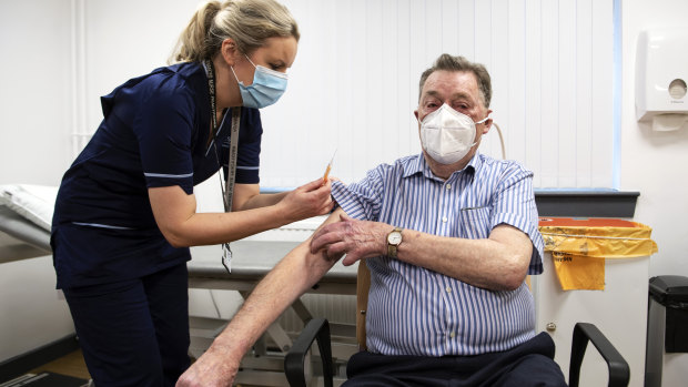 A nurse administers the AstraZeneca vaccine to a man in Dundee, Scotland, on January 4.