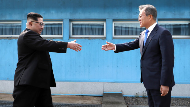North Korean leader Kim Jong-un prepares to shake hands with South Korean President Moon Jae-in.