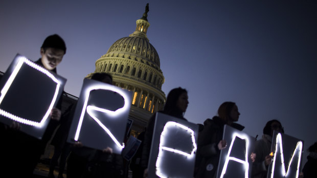 Demonstrators hold illuminated signs during a rally supporting the Deferred Action for Childhood Arrivals program (DACA), or the Dream Act, outside the US Capitol building earlier this year.