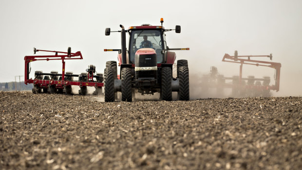 A tractor pulls a planter through a field in Illinois as corn is planted. QBE chief executive Pat Regan said many states across North America had an especially wet spring, which meant a large number of crops were not planted at all or planted late.