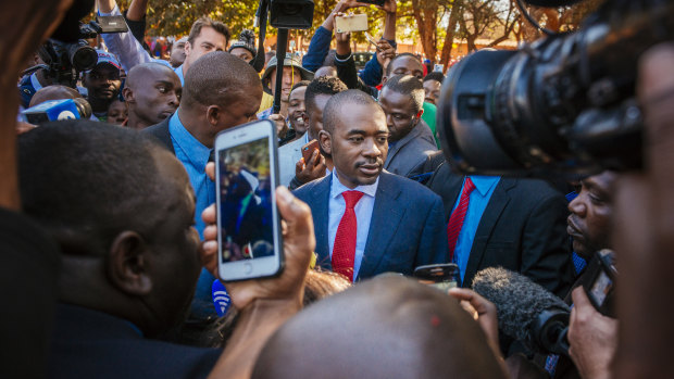 Nelson Chamisa, leader of the Movement for Democratic Change (MDC), centre, arrives to cast his vote at a polling station in the Kuwadzana township, in Harare.