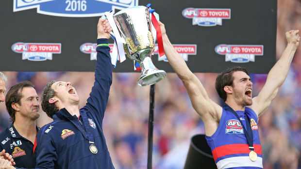 Murphy holds up the 2016 premiership cup with Easton Wood.