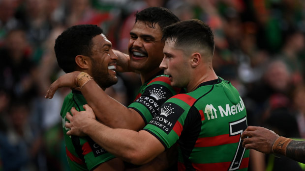 South Sydney players Taane Milne, Latrell Mitchell and Lachlan Ilias celebrate a try against the Tigers.