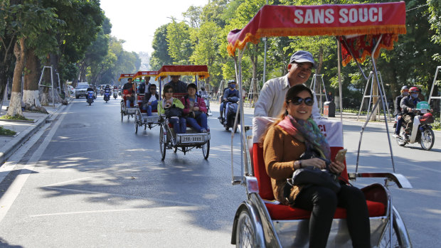 Chinese tourists ride rickshaws for sightseeing in Hanoi, Vietnam. China usually tops the list of number of tourists in Vietnam.