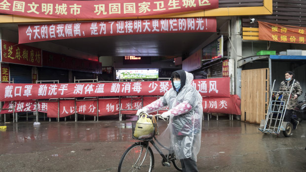 A shopper walks past a stall at a fresh produce market in Shanghai.