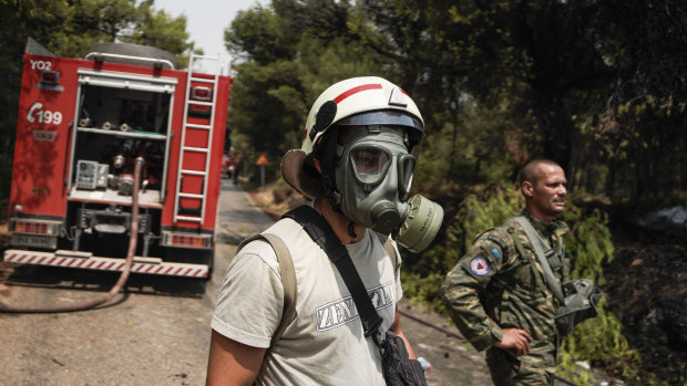 A firefighter works to contain a wildfire near Athens during a heatwave in Greece. Meanwhile, Sicily may have set a modern record for the hottest day ever in Europe on Friday, with a recorded temperature of 48.8 degrees.