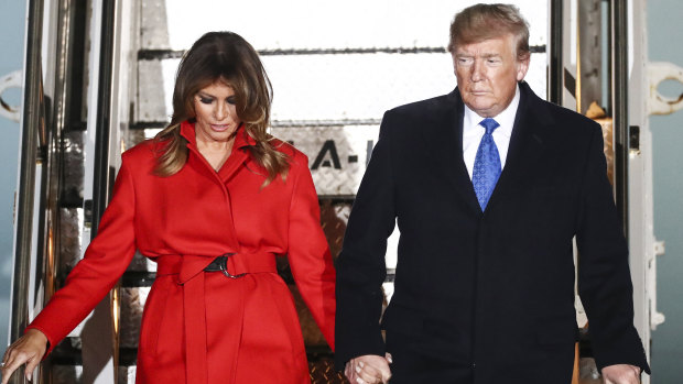 US President Donald Trump and first lady Melania Trump disembark from Air Force One after arriving at London Stansted Airport on Monday night.