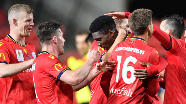 Adelaide congratulate Al Hassan Toure on his winner  against the Jets.