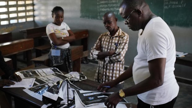 Congolese election commission officials seal the results of  elections in the St. Raphael school in the Limete district of Kinshasa, on December 3.