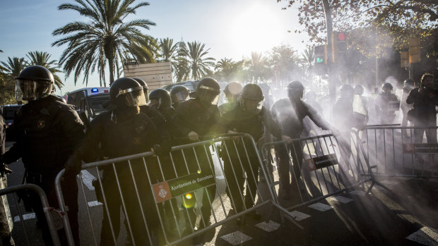 Riot police remove a barrier during a protest by supporters of Catalan independence on Paralelo Avenue in Barcelona, Spain.