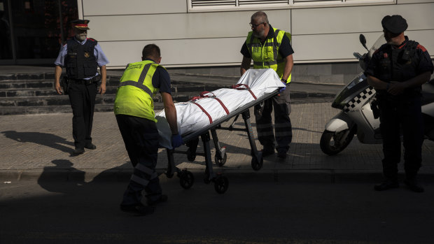 A body is taken away after an incident in the northern Spanish town of Cornella. 