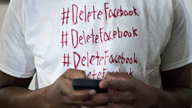 An attendee at the congressional hearing wears a hand made "Delete Facebook" t-shirt.