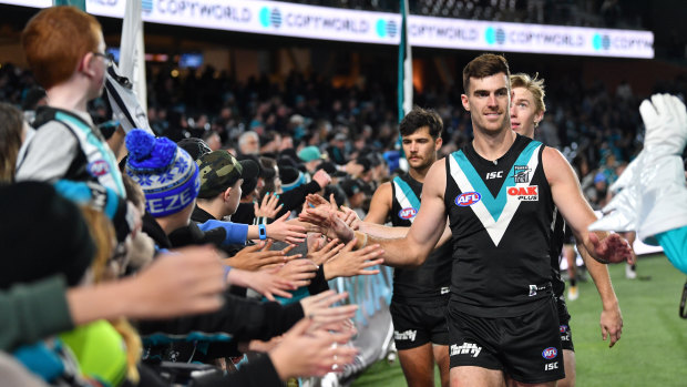 'Til next year: Scott Lycett and Port Adelaide teammates farewell fans after their win over Fremantle to end the season.