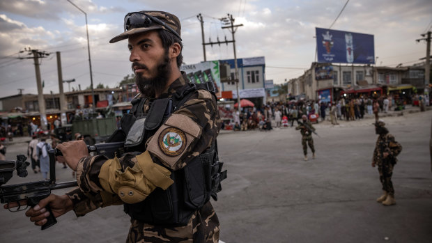 Taliban fighters control their positions near the entrance to the airport in Kabul on Monday.