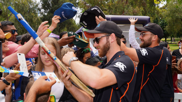 Kane Williamson and Blundell sign autographs during a media opportunity at the MCG.