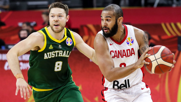 Hot on the heels: Australia's Matthew Dellavedova pressures Cory Joseph of Canada during the first round match at the FIBA World Cup in China.