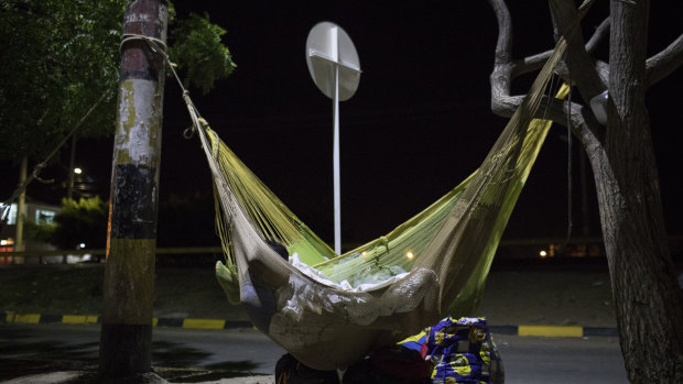 A Venezuelan migrant sleeps in a hammock at a bus terminal in Maicao, La Guajira, Colombia.