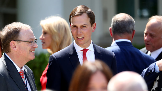 Jared Kushner, senior White House adviser, centre, speaks with attendees after Trump presented the plan believed to be his.