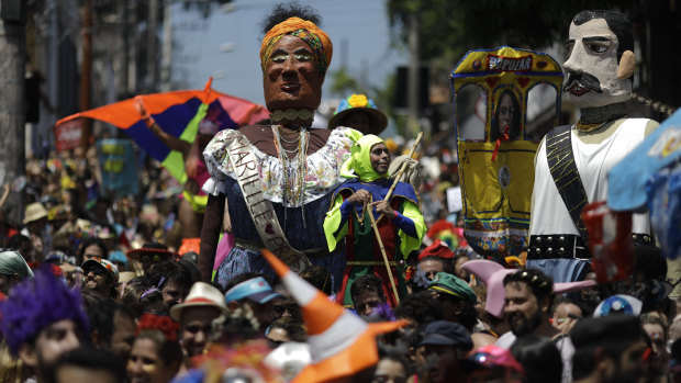 Revelers perform next to a giant puppet depicting the slain councilwoman Marielle Franco.