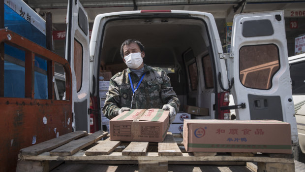 A vendor unloads boxes of goods at the Baishazhou wet market in Wuhan, Hubei Province, China. 