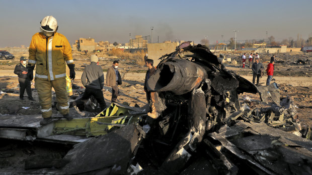 Rescue workers search the scene where a Ukrainian plane crashed in Shahedshahr, near the Iranian capital Tehran on Wednesday.