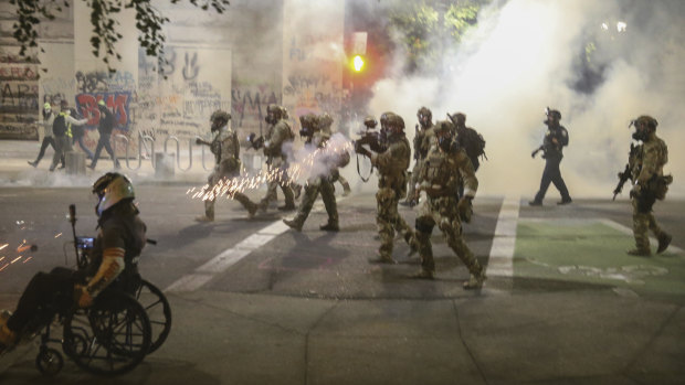 Militarised federal agents deployed by the President to Portland, Oregon, fire tear gas at protesters.