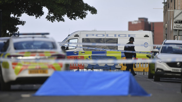 A police officer and vehicles are seen at a cordon in Irving Street in Birmingham.