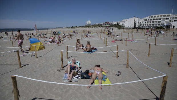 We live in a socially distanced world now. Here, sunbathers lie in an area marked to enforce social distancing measures in La Grande Motte, southern France