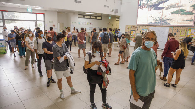 Voters wait in line to cast their vote at a polling station in Tel Aviv, Israel.