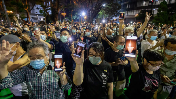 People attend the vigil in Victoria Park commemorating events at Tiananmen Square.