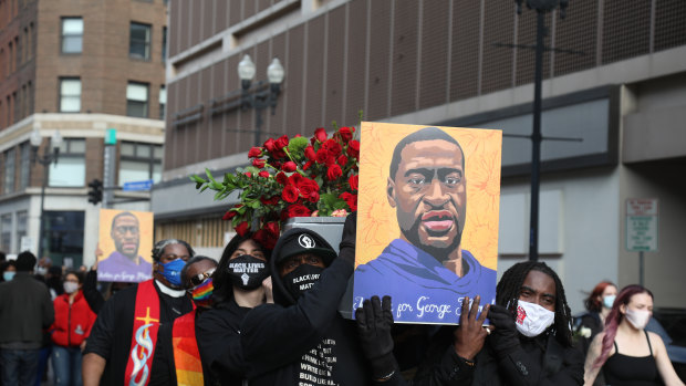 Demonstrators carry a symbolic coffin and images of George Floyd during an ‘I Can’t Breathe’ Silent March For Justice in Minneapolis, Minnesota, ahead of the trial.