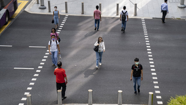 Singapore has adopted some social distancing measures to curb the spread of the virus, but had let schools, offices and restaurants remain open.