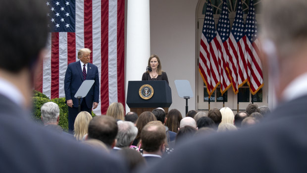 Closely clustered people at the Rose Garden event on Saturday for Amy Coney Barrett, US President Donald Trump's nominee for associate justice of the Supreme Court.