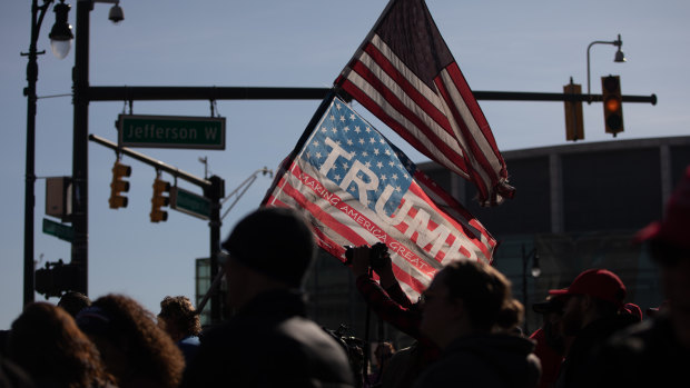 Demonstrators wave American flags at a pro-Trump protest in front of the TCF Centre during the 2020 Presidential election in Detroit, Michigan.