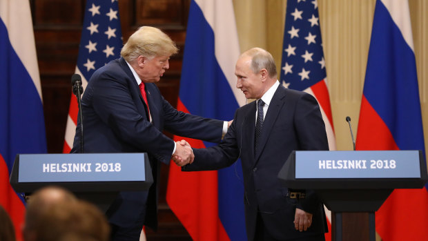 US President Donald Trump shakes hands with Russia's President Vladimir Putin during a news conference in Helsinki, Finland, on Monday.