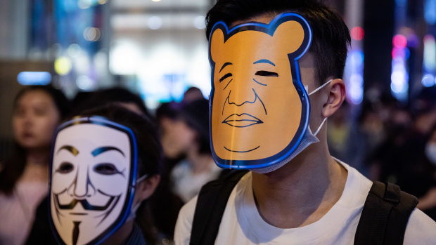 Masked 'Halloween' protesters walk in the Central district of Hong Kong, China, on Thursday.