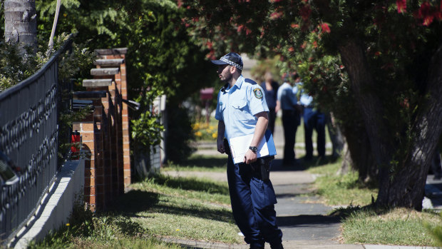 Police at the property hours after the fire that left a woman dead. 