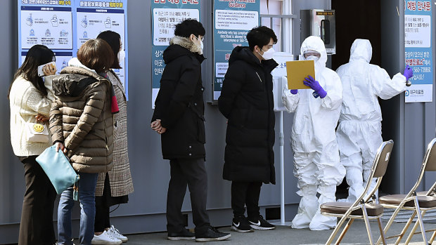 People suspected of being infected with coronavirus wait to receive tests at a medical centre in Daegu, South Korea.