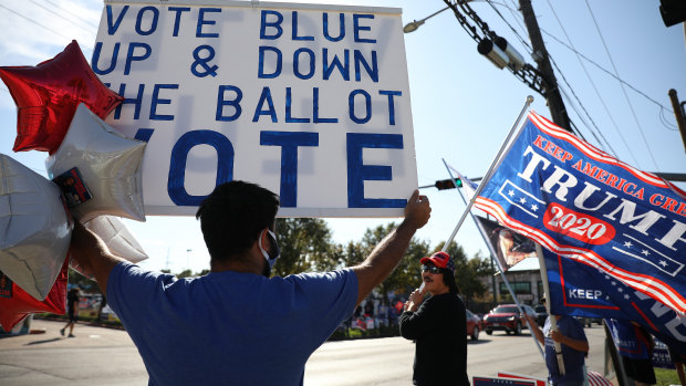 The great American divide reflected outside a polling location in Houston, Texas.