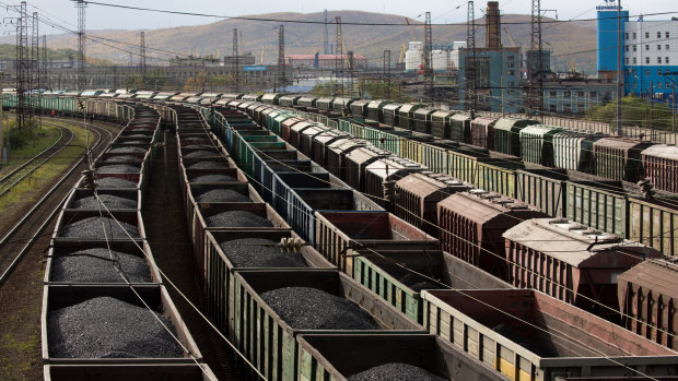 Ready to export: Freight wagon filled with coal line the railway tracks at Russia's Murmansk station.
