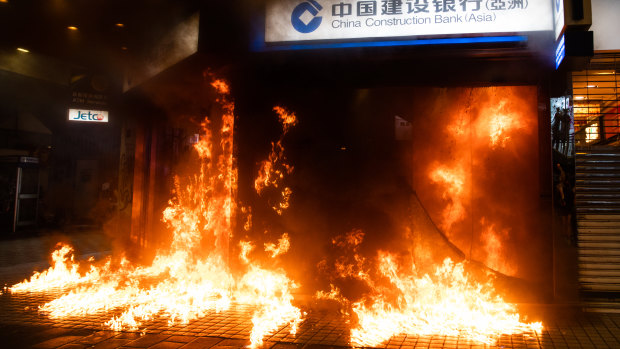 Demonstrators set fire to a China Construction Bank during a protest in the Causeway Bay of Hong Kong.