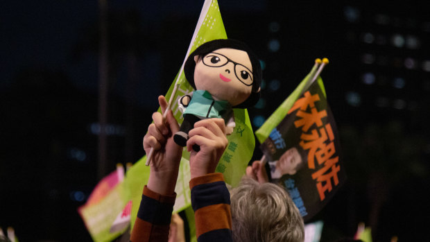 An attendee holds a doll in the likeness of Taiwanese President Tsai Ing-wen during a rally for her campaign in Taipei on Friday.