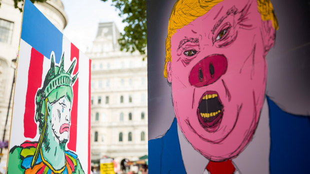 Demonstrators hold placards during a protest against Donald Trump in central London earlier this month.