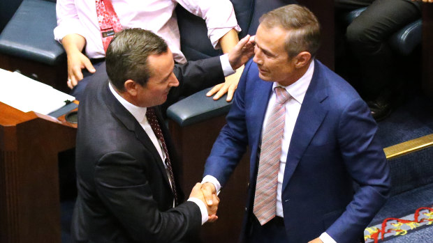 Premier Mark McGowan and Health Minister Roger Cook celebrate on the floor of WA's Legislative Assembly after the passage of the government's euthanasia legislation.