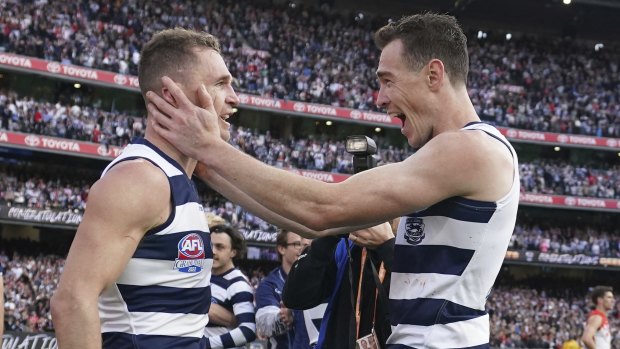 Jeremy Cameron, right, celebrates his first premiership win with inspirational skipper Joel Selwood.