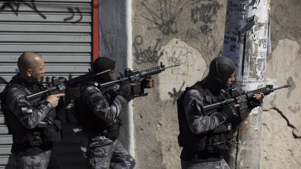Gang related violence: elite police patrol one day after coming under fire during a shift change in the Alemao slum complex in Rio de Janeiro, Brazil.