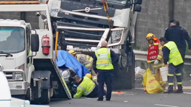Crash investigators at the scene the day after four police  were struck and killed by a truck on the Eastern Freeway.  