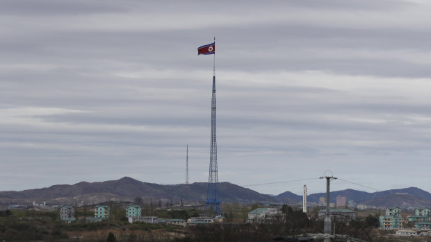A North Korean flag flutters in the wind atop a 160-metre tower in North Korea.